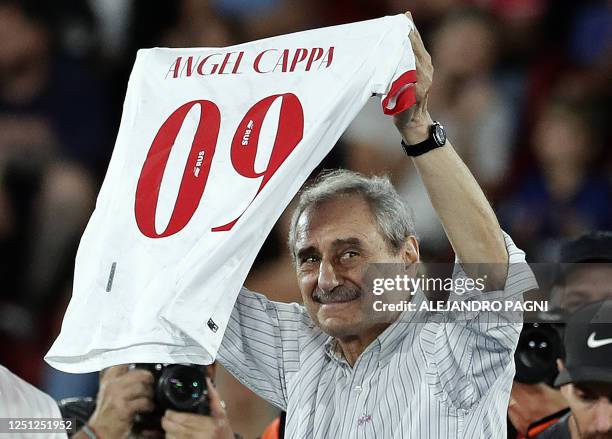 Huracan's former coach and player Angel Cappa receives a recognition from his ex club before the Argentine Professional Football League match between...