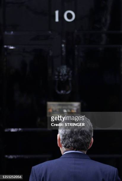 British Prime Minister Gordon Brown returns to 10 Downing Street after to addressing the media, in central London on May 10, 2010. Brown announced...