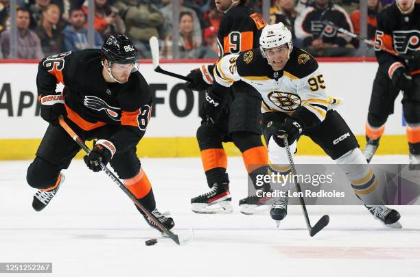 Joel Farabee of the Philadelphia Flyers controls the puck while being pursued by Vinni Lettieri of the Boston Bruins at the Wells Fargo Center on...