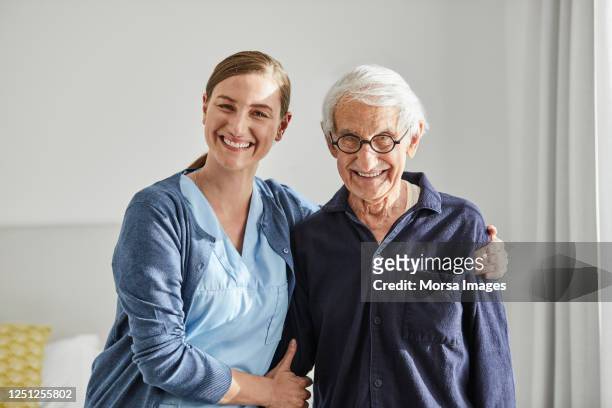 happy senior male with female caregiver - care stock-fotos und bilder