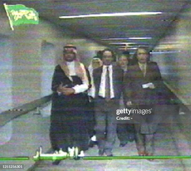 Video grab off of Libyan Television shows the two suspects wanted for the 1988 bombing of an airliner over Lockerbie, Scotland, as they are escorted...