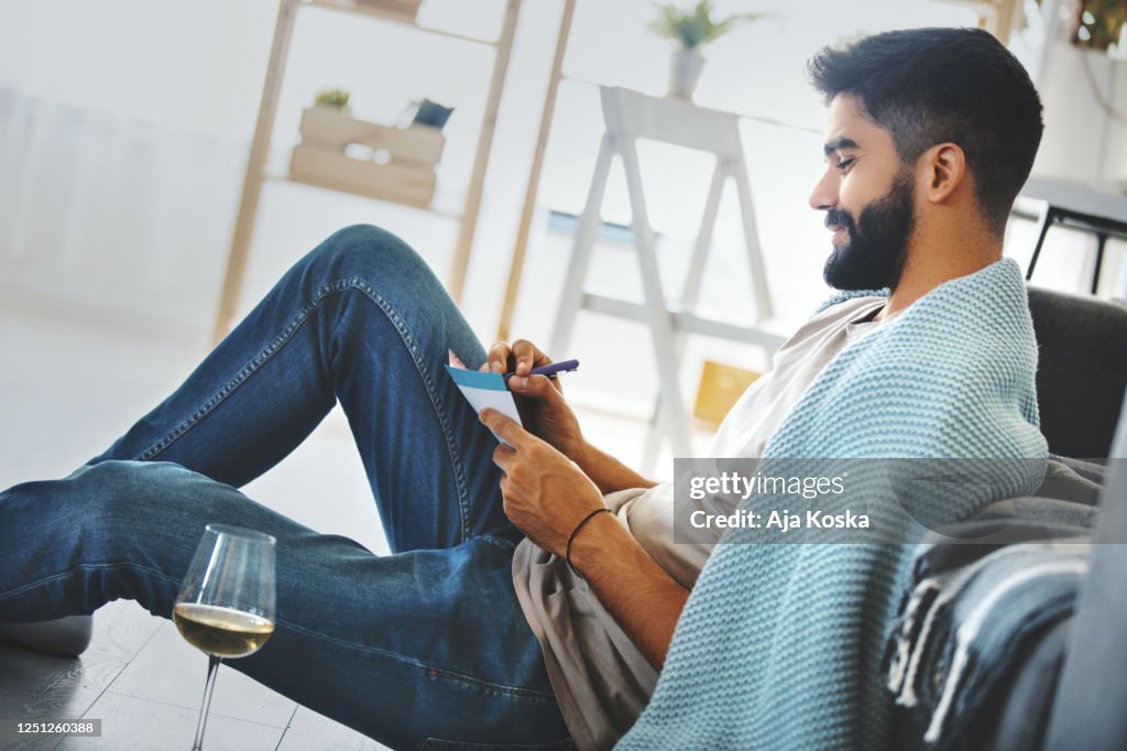 Young man writing a letter.