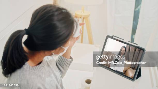 asian woman lying on a bad doctor consult a doctor about medications and medical conditions via video call at home,home healthcare and telemedicine concept - ems fitness stock pictures, royalty-free photos & images