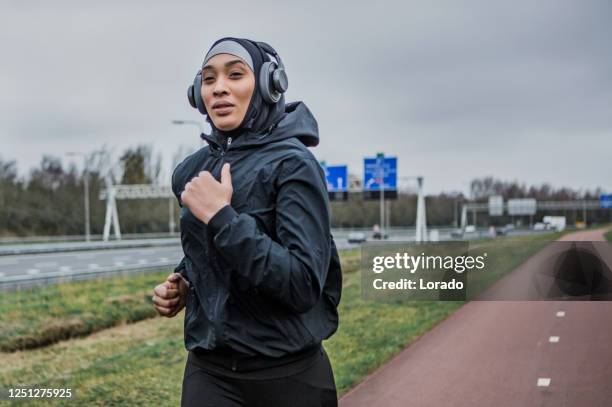 mooie vrouwelijke atleet die een sportenhijab draagt - nederland stockfoto's en -beelden