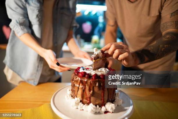 cutting a perfect slice of cake - sharing cake stock pictures, royalty-free photos & images