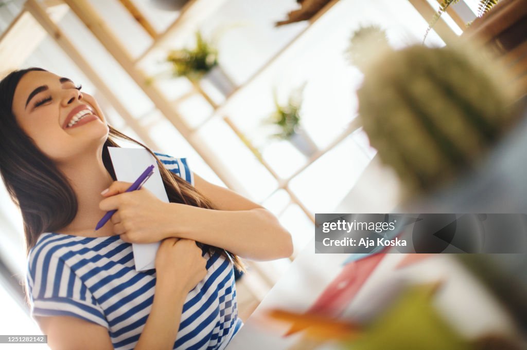 Young woman writing a letter.