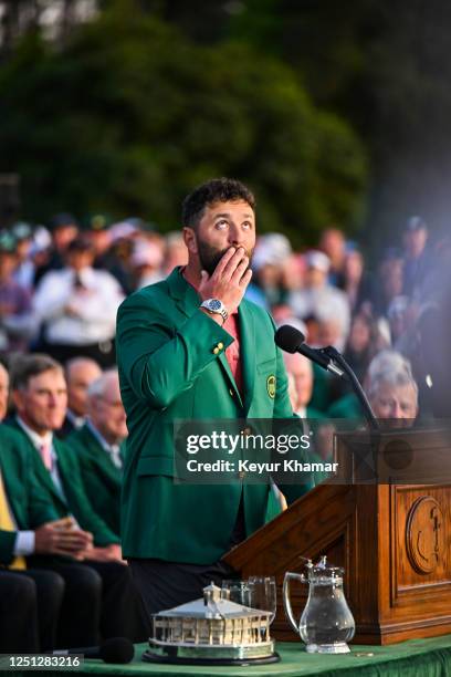 Jon Rahm of Spain thanks late Spanish golfer Seve Ballesteros while receiving the green jacket during a ceremony and trophy presentation following...