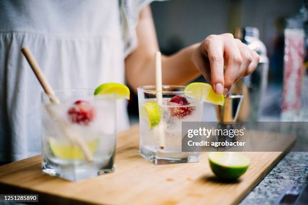 making home made gin and tonic - gin tasting stock pictures, royalty-free photos & images