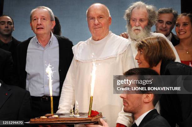 French actor Michel Bouquet prepares to blow the candles on his birthday cake next to French Culture Minister Christine Albanel and director Georges...