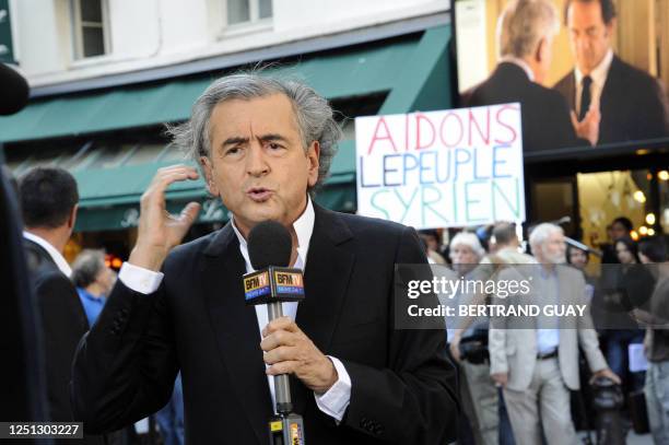 French philosopher Bernard-Henri Levy speaks to French BFM TV channel on July 4, 2011 in Paris, prior to attending a meeting called "SOS Syria" with...