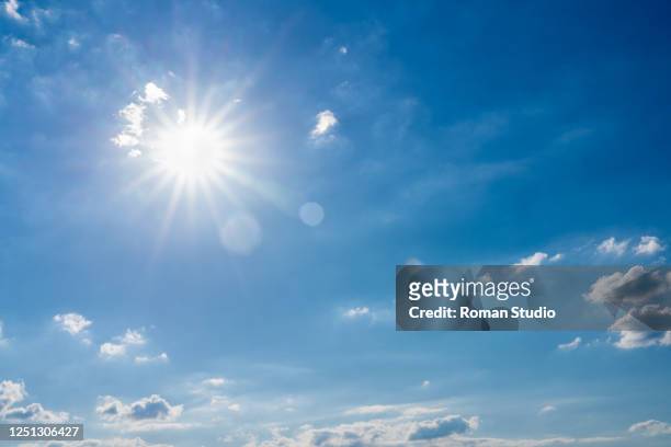 blue sky and white clouds background. clouds in the blue sky - sunlight stock-fotos und bilder