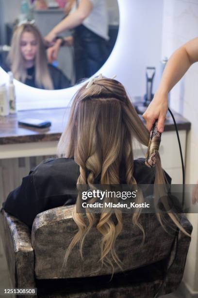jong tienerje dat haar haar havong gekruld in een kapsalon, die zich voor graduatieviering voorbereidt - haar straighten stockfoto's en -beelden