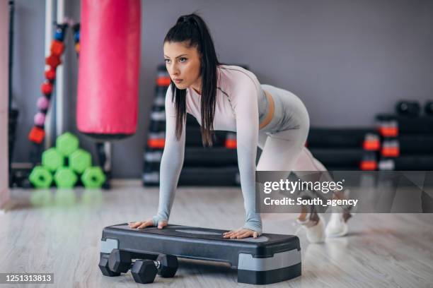 woman exercising on the step platform - aerobic stepper stock pictures, royalty-free photos & images