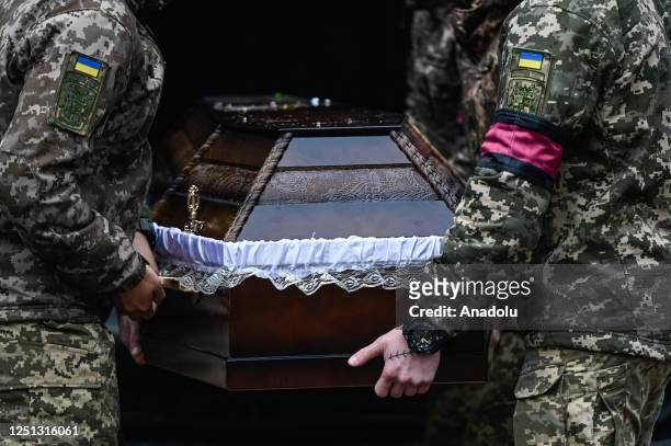 Ukrainian soldiers carry the coffin of the fallen soldier Evgeny Gulevich as they arrive for the burial at the Field of Mars in Lviv, Ukraine on...