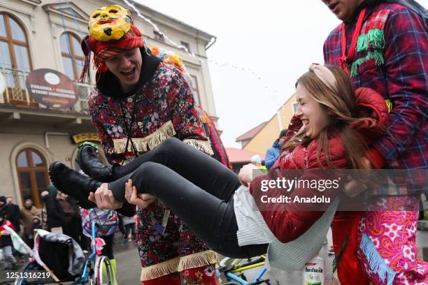 Men with traditional costumes carry a girl during the âSmiergustyâ celebration in Wilamowice, Poland on April 10, 2023. Every year on Easter Monday...