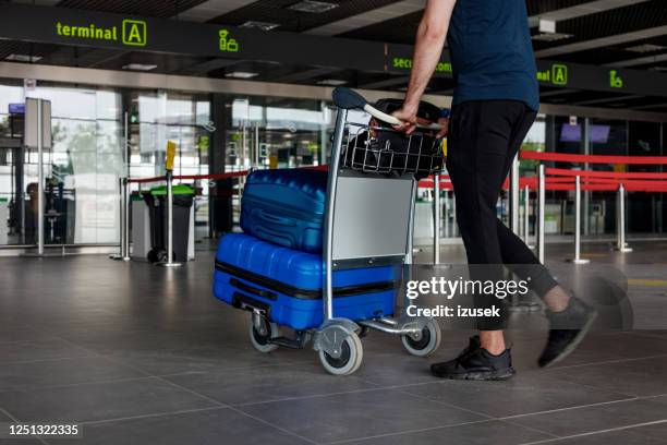 passengers at the airport with luggage - luggage trolley stock pictures, royalty-free photos & images