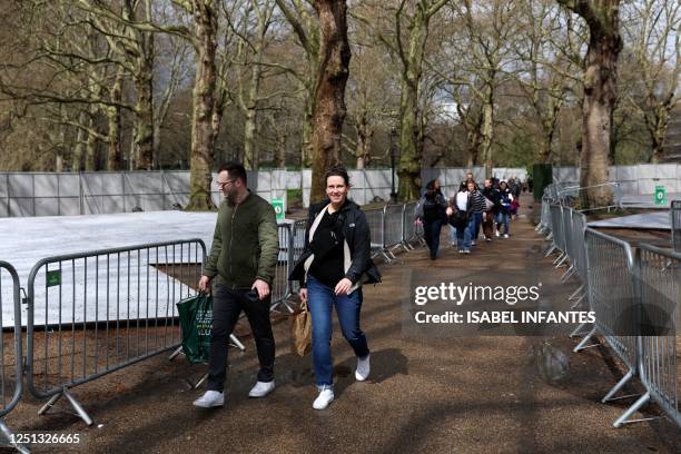 Tourists walk past barriers erected in Green Park, near Buckingham Palace in central London on April 10 as preparations get underway ahead of the...