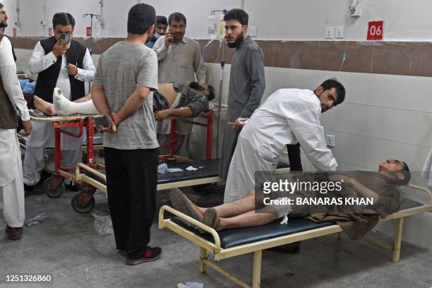 Paramedics give medical treatment to injured bomb blast victims at a hospital in Quetta on April 10, 2023. - At least four people were killed and 15...