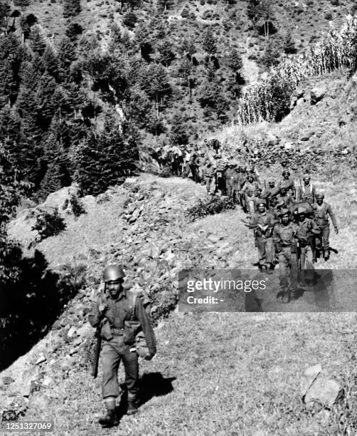 Picture dated September 13, 1965 shows a column of Indian soldiers progressing in the Haji-Pir gorge during the Second Indo-Pakistani War, known as...