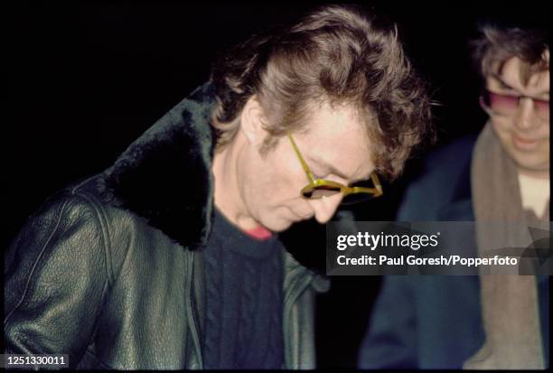 Late afternoon in New York City former Beatles musician John Lennon signs a copy of his "Double Fantasy" album for Mark David Chapman outside the...