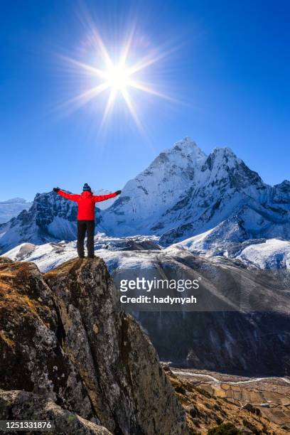 woman watching sunrise over himalayas, mount everest national park - himalayas sunrise stock pictures, royalty-free photos & images