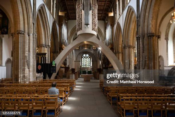 Man sits in Llandaff Cathedral which opened its doors today after being closed for three months on June 22, 2020 in Cardiff, United Kingdom. The...