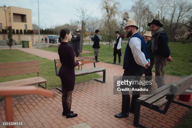 Boys and younger men from the Ilosvai Selymes Peter folk dance group attend the traditional watering of local girls on Easter Monday in Komarovce,...