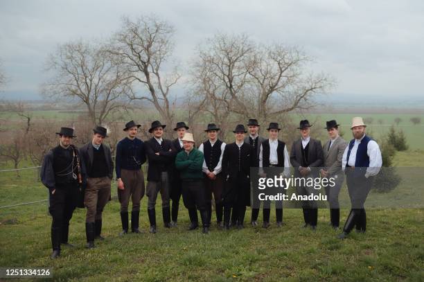Boys and younger men from the Ilosvai Selymes Peter folk dance group pose for a group photograph in front of a church as they attend the traditional...