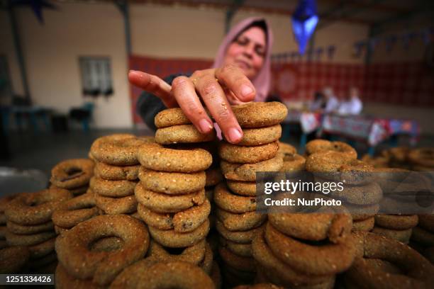Palestinian women make traditional date-filled cookies in preparation for the Eid al-Fitr holiday, in Gaza City, on April 10, 2023. - Muslims around...