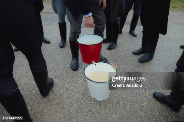 Boys and younger men from the Ilosvai Selymes PÃ©ter folk dance group prepare buckets of cold water as they attend the traditional watering of local...