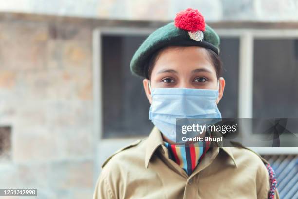 a young girl in ncc uniform and wearing protective mask. - indian military stock pictures, royalty-free photos & images