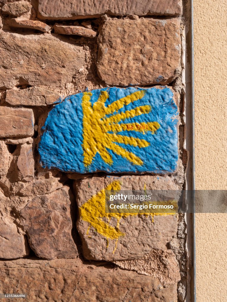 Yellow arrow and star signs show the way to Santiago de Compostela, Navarra, Spain