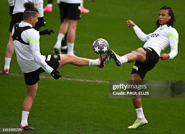 Manchester City's English midfielder Kalvin Phillips and Manchester City's Dutch defender Nathan Ake attend a team training session at Manchester...