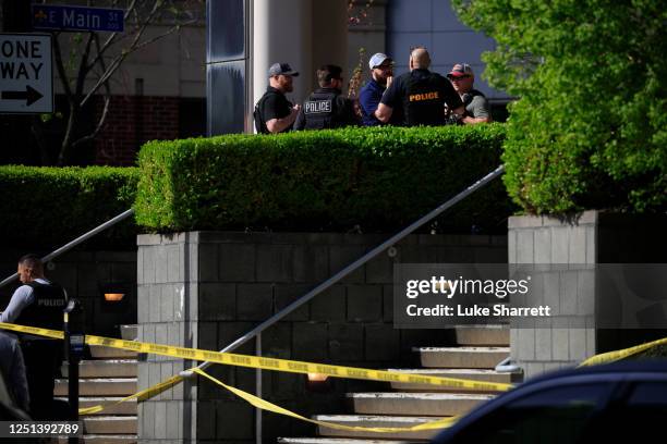 Law enforcement officers gather outside the front entrance of the Old National Bank building after a gunman opened fire on April 10, 2023 in...