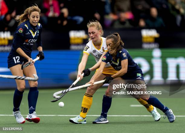 Den Bosch's Emma Reijnen fights for the ball with Madrid's Maria Lopez Garcia and Inma Hofmeister during the Women's Euro Hockey League final field...