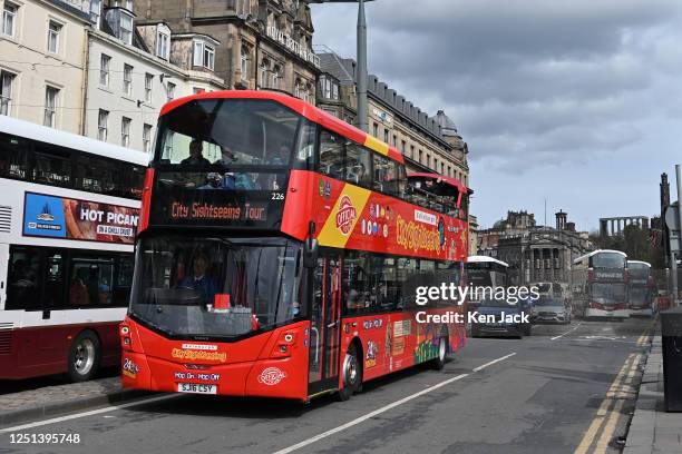 Sightseeing bus makes its way along Edinburgh's main thoroughfare, Princes Street, on Easter Monday, with some of the city's famous landmarks in the...