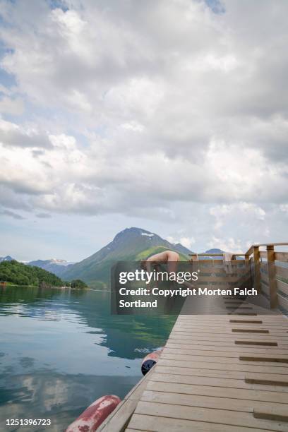 young man diving into a lake in halsa, norway - skinny dipping stock pictures, royalty-free photos & images