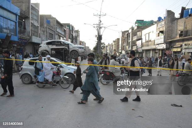 Pakistan security forces inspect the damaged vehicles after the explosion targeting a security vehicle in Quetta, Pakistan on April 10, 2023. At...