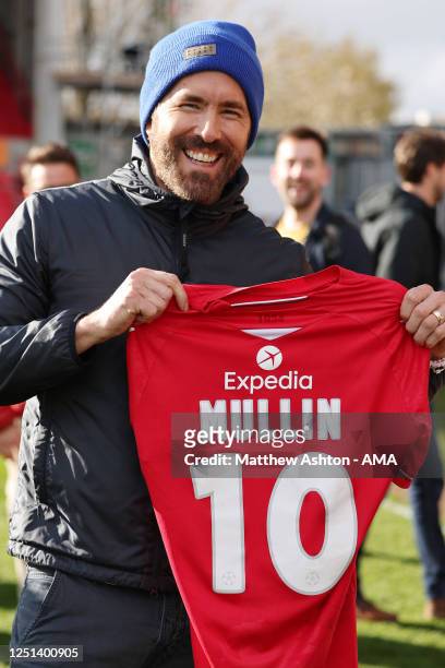 Hollywood actor and co-owner of Wrexham Football Club, Ryan Reynolds takes the shirt of Paul Mullin of Wrexham during the Vanarama National League...