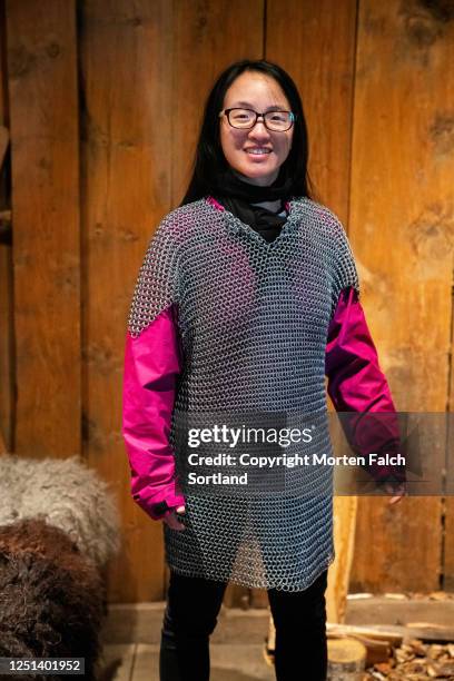 chinese woman wearing a chain mail shirt in bøstad, norway - chain mail stock pictures, royalty-free photos & images