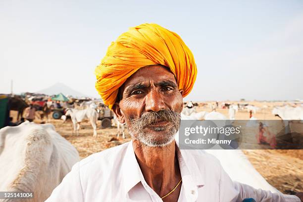 indian cattle merchant pushkar camel fair real people portrait series - farmer confident serious stock pictures, royalty-free photos & images