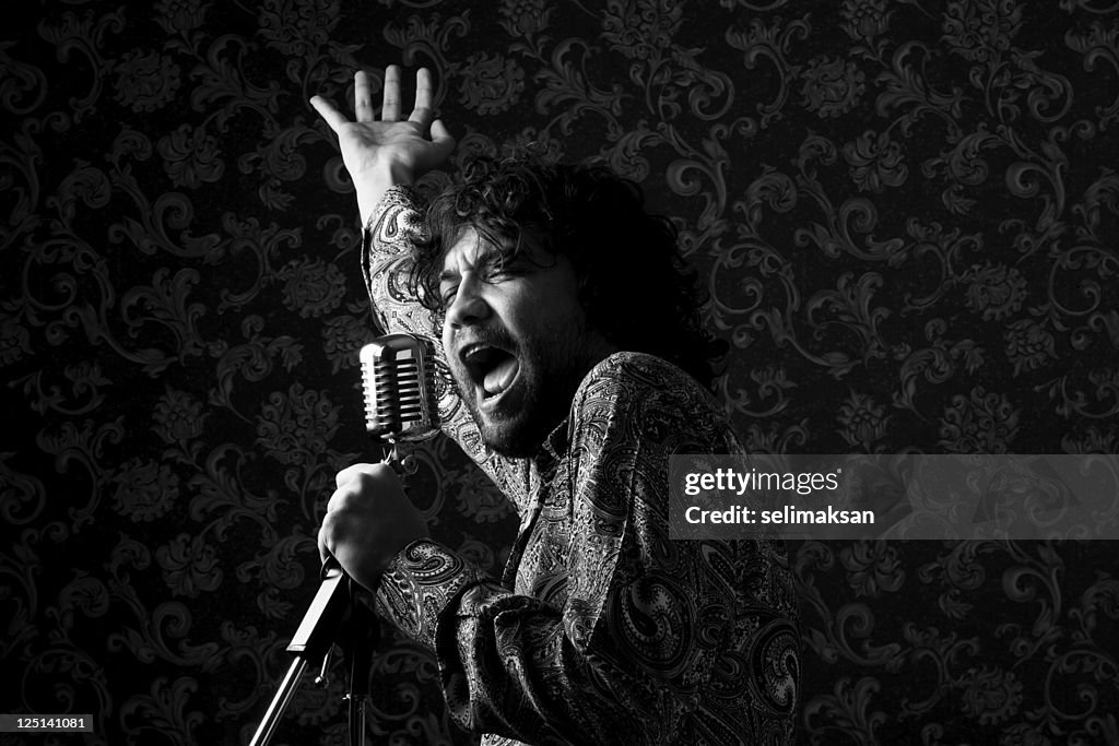 Seventies rock star singing on old fashioned microphone