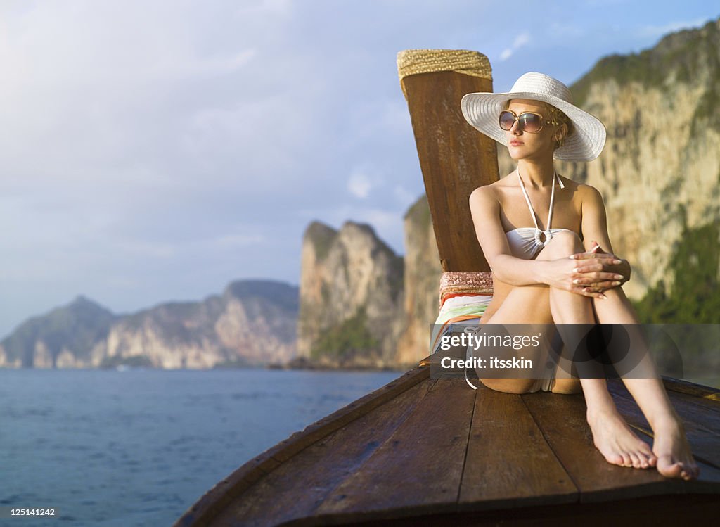 Woman on the boat watching sunset