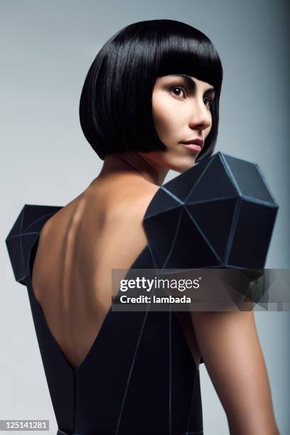 fashion portrait of woman in futuristic dress - young woman looking over shoulder stock pictures, royalty-free photos & images