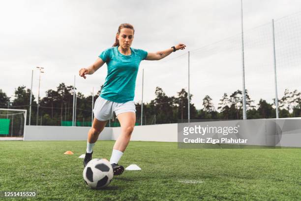female soccer player - taking a shot sport stock pictures, royalty-free photos & images