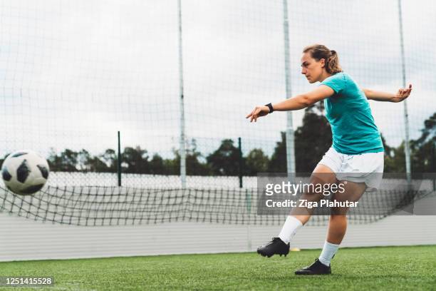 young woman shooting on a goal - female soccer - rematar à baliza imagens e fotografias de stock