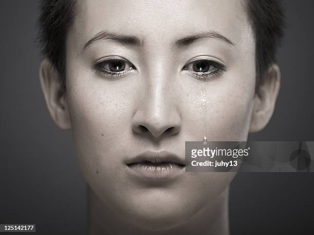 portrait of young asian girl with tear rolling down cheek - pain face portrait bildbanksfoton och bilder