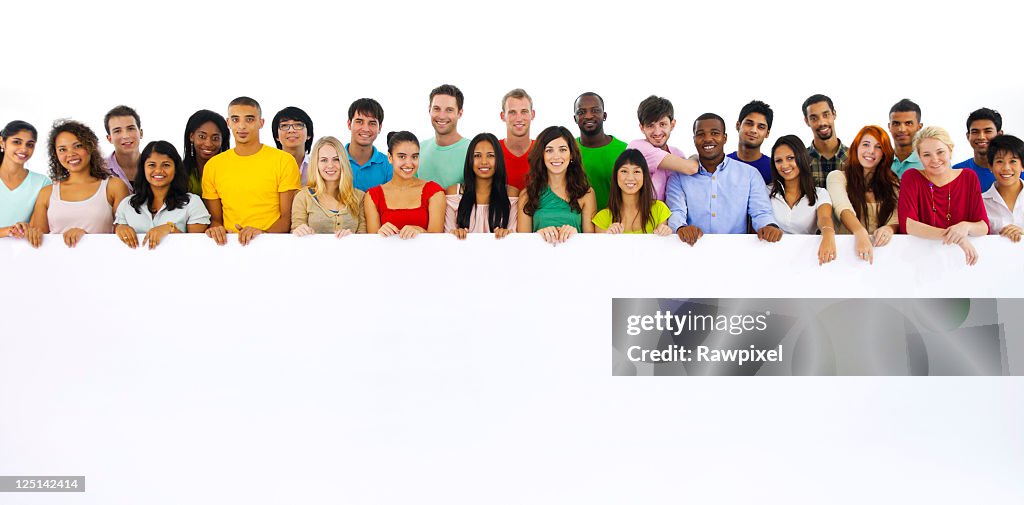 Large group of multi ethnic youths holding a placard