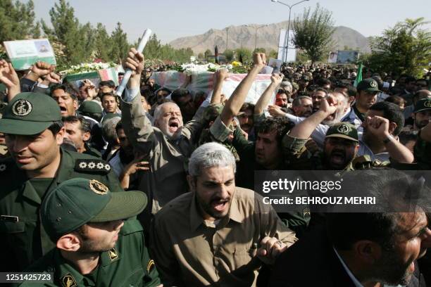 Iranians carry the coffin of General Nur-Ali Shushtari, deputy commander of the Revolutionary Guards ground forces and other members of the...