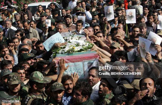 Iranians carry the coffin of General Nur-Ali Shushtari, deputy commander of the Revolutionary Guards ground forces, killed two days ago, near the...